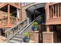 Close-up of the brick stairs to the condo entrance, with potted plants and wooden railings at 323 8Th Ne St # 7, Atlanta, GA 30309