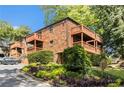 Brick condo building with wooden balconies and greenery at 323 8Th Ne St # 7, Atlanta, GA 30309