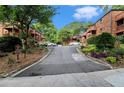 Street view of a brick condo complex with wooded scenery at 323 8Th Ne St # 7, Atlanta, GA 30309