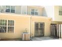 View of backyard featuring beige siding, sliding door, air conditioning unit and chainlink fence at 6460 Wellington Chase Ct, Lithonia, GA 30058