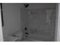 Renovated bathroom featuring marble-like tile on the wall around the bathtub at 6460 Wellington Chase Ct, Lithonia, GA 30058