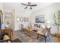 Inviting living room with vaulted ceiling, stylish furniture, and hardwood flooring at 208 Starr Cir, Stockbridge, GA 30281