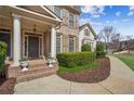 Inviting front porch with white pillars and well-manicured landscaping at 3915 Northridge Dr, Cumming, GA 30040