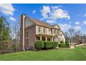 Brick home with manicured lawn and landscaping on a sunny day at 3915 Northridge Dr, Cumming, GA 30040