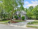 Attractive house with manicured lawn, mature trees, and long driveway at 420 Big Bend Trl, Sugar Hill, GA 30518