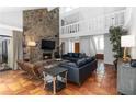 Inviting living room with a stone fireplace, high ceilings, and large windows for natural light at 4531 Kings Lake Dr, Marietta, GA 30067