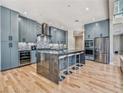 Modern kitchen with an island, stainless steel appliances, and custom cabinets at 7504 Rivertown Rd, Fairburn, GA 30213