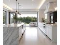 Bright, modern kitchen with marble countertops, stainless steel appliances and a view of the water at 7504 Rivertown Rd, Fairburn, GA 30213