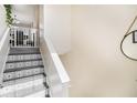 Unique staircase with custom-designed tiling and white risers and banisters at 7760 Poppy Dr, Winston, GA 30187