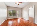 Bedroom with hardwood floors, large window and access to the balcony at 1250 Parkwood Se Cir # 1203, Atlanta, GA 30339