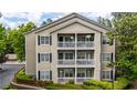 Multi-level home featuring white balconies, black shutters and nicely landscaped front yard at 1250 Parkwood Se Cir # 1203, Atlanta, GA 30339