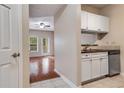 View from doorway of kitchenette with white cabinets and black countertops at 1250 Parkwood Se Cir # 1203, Atlanta, GA 30339