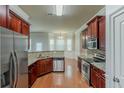 Well-equipped kitchen with stainless steel appliances and granite countertops, adjacent to a bright dining area at 3912 Margaux Dr, Atlanta, GA 30349