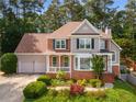 Charming two-story home with a manicured front yard and two-car garage at 825 Yosemite Dr, Suwanee, GA 30024