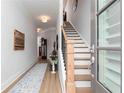 Inviting entryway with wood floors, staircase, decorative rug, and an open door to welcome guests at 1717 Cosette Ln, Kennesaw, GA 30152