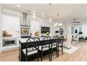 Modern kitchen featuring a central island, stylish pendant lights, and seamless flow to the living area at 1717 Cosette Ln, Kennesaw, GA 30152