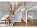 Spacious staircase boasts wood treads, wrought iron spindles, wood handrail, and a large landing providing an open feel at 395 Clubfield Dr, Roswell, GA 30075