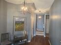 Entryway with hardwood floors, decorative lighting, an adjacent staircase and a landscape painting at 106 Trailside Way, Hiram, GA 30141