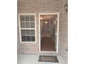 Inviting entryway featuring a 'Welcome' mat and view into a hardwood floored foyer at 106 Trailside Way, Hiram, GA 30141