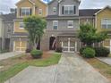 Charming townhome with brick accents, attached garage, and well-maintained landscaping at 106 Trailside Way, Hiram, GA 30141