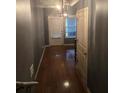 Hallway featuring gleaming hardwood floors and modern lighting fixtures at 106 Trailside Way, Hiram, GA 30141