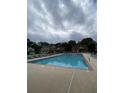 Community pool area with surrounding greenery offering a refreshing escape at 106 Trailside Way, Hiram, GA 30141