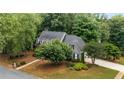 Picturesque aerial view of a home with lush greenery and a well-maintained lawn at 1061 Polo Club Nw Dr, Marietta, GA 30064