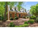 Inviting home exterior featuring brick facade, manicured landscaping, and a welcoming entrance at 1061 Polo Club Nw Dr, Marietta, GA 30064