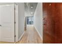 Hallway leading to a living area with views of the city skyline through large windows at 3324 Peachtree Ne Rd # 1407, Atlanta, GA 30326