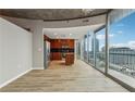 Modern kitchen with wood cabinets, stainless steel appliances, island, and bright city views from expansive windows at 3324 Peachtree Ne Rd # 1407, Atlanta, GA 30326