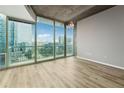 Spacious living room with floor-to-ceiling windows offering panoramic city views and ample natural light at 3324 Peachtree Ne Rd # 1407, Atlanta, GA 30326