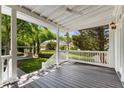 Spacious back porch with a view of the landscaped yard and a white picket fence at 3848 Saint Annes Ct, Duluth, GA 30096