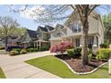 Street view of craftsman homes with manicured lawns, driveways, and mature trees at 516 Winder Trl, Canton, GA 30114