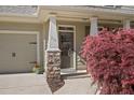 Inviting front porch with stone columns, house number, and colorful landscaping at 516 Winder Trl, Canton, GA 30114