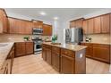 Spacious kitchen featuring an island, stainless steel appliances, and beautiful wood cabinetry at 325 Cranbrooke Cir, Suwanee, GA 30024