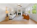 Bright living room with large windows, fireplace, and neutral decor at 325 Cranbrooke Cir, Suwanee, GA 30024