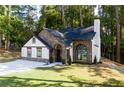 Attractive home with stone and white exterior, an arched entry, and lush landscaping on a well maintained lawn at 3563 Brenda Ct, Douglasville, GA 30135