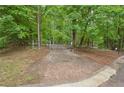 Gated property line nestled among lush green trees at 5259 Sugar Ridge Dr, Sugar Hill, GA 30518