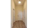 Entryway with wood floors, white walls, and two white doors at 870 Mayson Turner Nw Rd # 1447, Atlanta, GA 30314