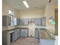 Kitchen featuring gray cabinets, granite countertops, and stainless steel sink with view of pendant lights at 870 Mayson Turner Nw Rd # 1447, Atlanta, GA 30314