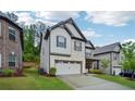 Side view of a two-story home with a well-maintained lawn, two-car garage and gray accents at 1867 Castleberry Ln, Buford, GA 30518