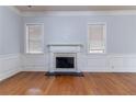 Bright living room with hardwood floors, fireplace, and white trim at 204 Saintvry Path, Atlanta, GA 30349