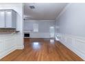 Spacious living room featuring hardwood floors, white trim, and access to the outside at 204 Saintvry Path, Atlanta, GA 30349