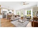 Open floor plan featuring a bright living room with modern furnishings and a view to the kitchen at 213 Starr Cir, Stockbridge, GA 30281