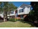 This lovely home has a combination brick and vinyl exterior, attached garage, and manicured landscaping at 3265 Bethesda Park Ct, Lawrenceville, GA 30044