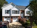 Inviting two-story home with a combination brick and vinyl exterior, attached garage, and manicured landscaping at 3265 Bethesda Park Ct, Lawrenceville, GA 30044