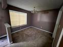 A spacious living room with a window provides natural light, enhancing the room's appeal and comfort at 2572 Stratford Ln, Morrow, GA 30260