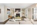 Bright living room with fireplace, built-in shelving, and shuttered windows at 2814 Vinings Central Se Dr # 151, Atlanta, GA 30339