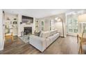 Living room featuring a fireplace, built-in shelving, and wood floors at 2814 Vinings Central Se Dr # 151, Atlanta, GA 30339