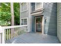 Inviting front entrance with a gray wood porch and painted siding at 1438 N Crossing Ne Dr, Atlanta, GA 30329